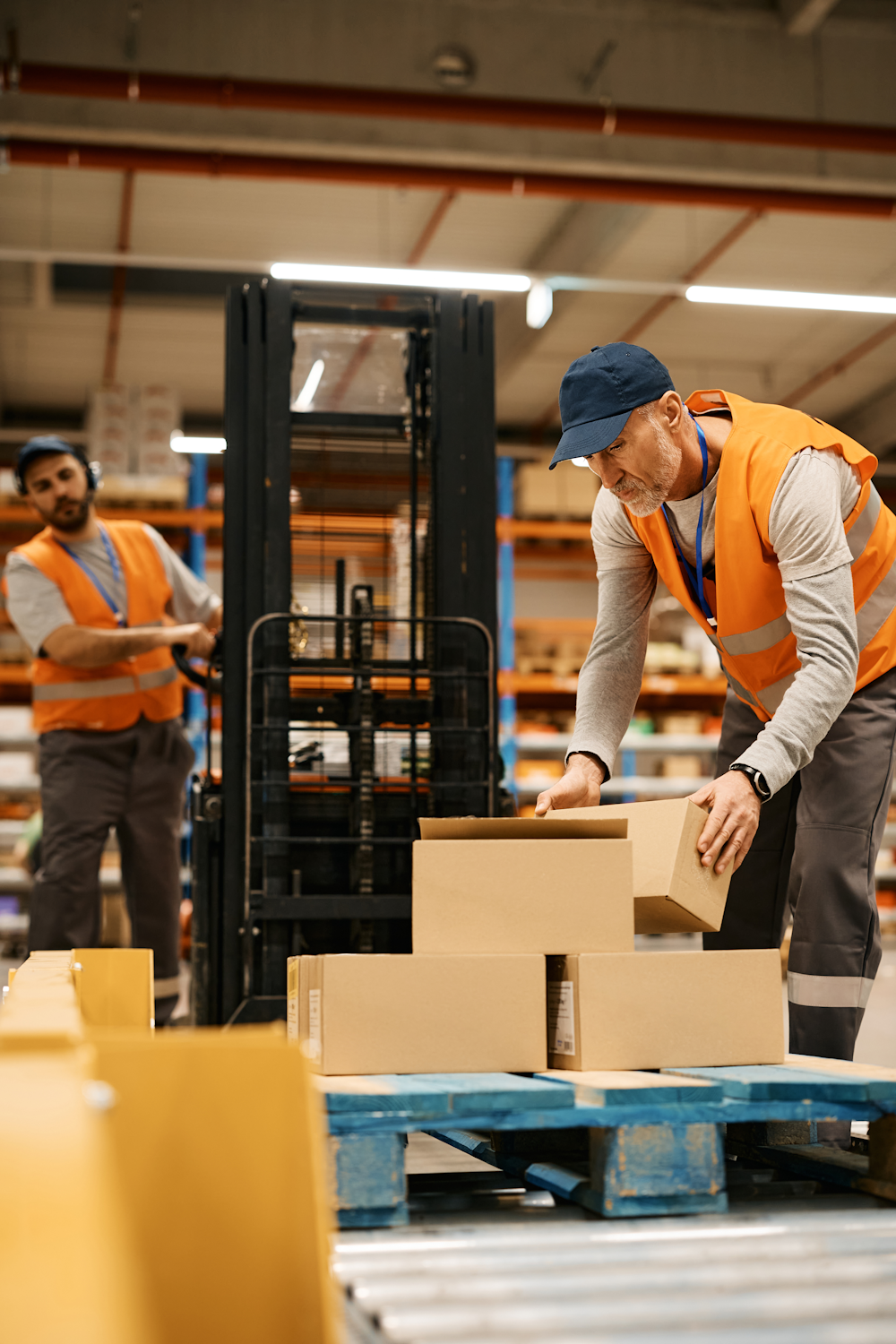 Warehouse workers operating forklift
